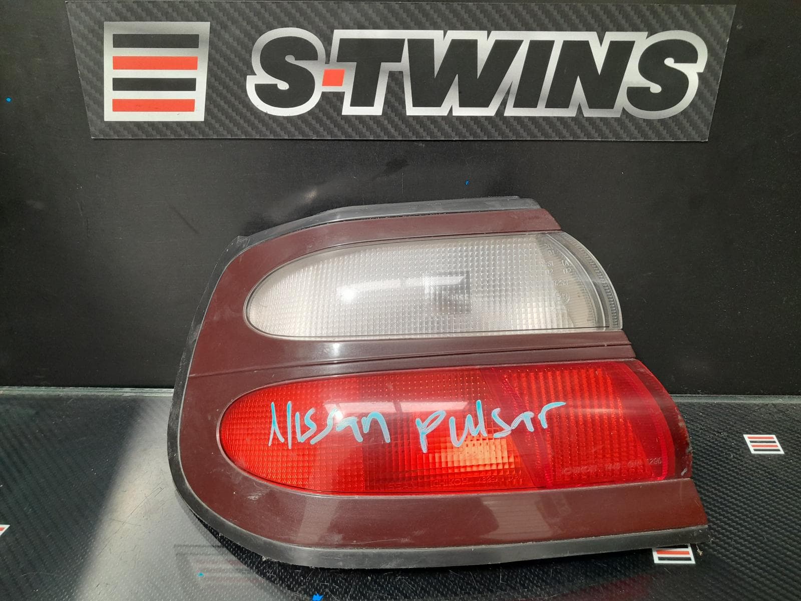 Used auto part listing image: 2000 NISSAN PULSAR LEFT TAILLIGHT N15, HATCH, ICHIKOH LENS# 7446, 03/98-06/00 0000168445