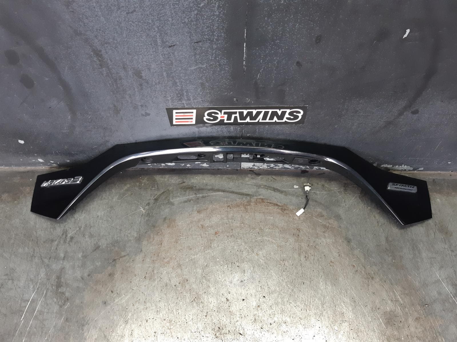 Used auto part listing image: 2014 MAZDA 3 REAR GARNISH TAILGATE GARNISH, W/ CAMERA, W/ SMART KEY TYPE, BM-BN, 11/13-02/19 0000321805