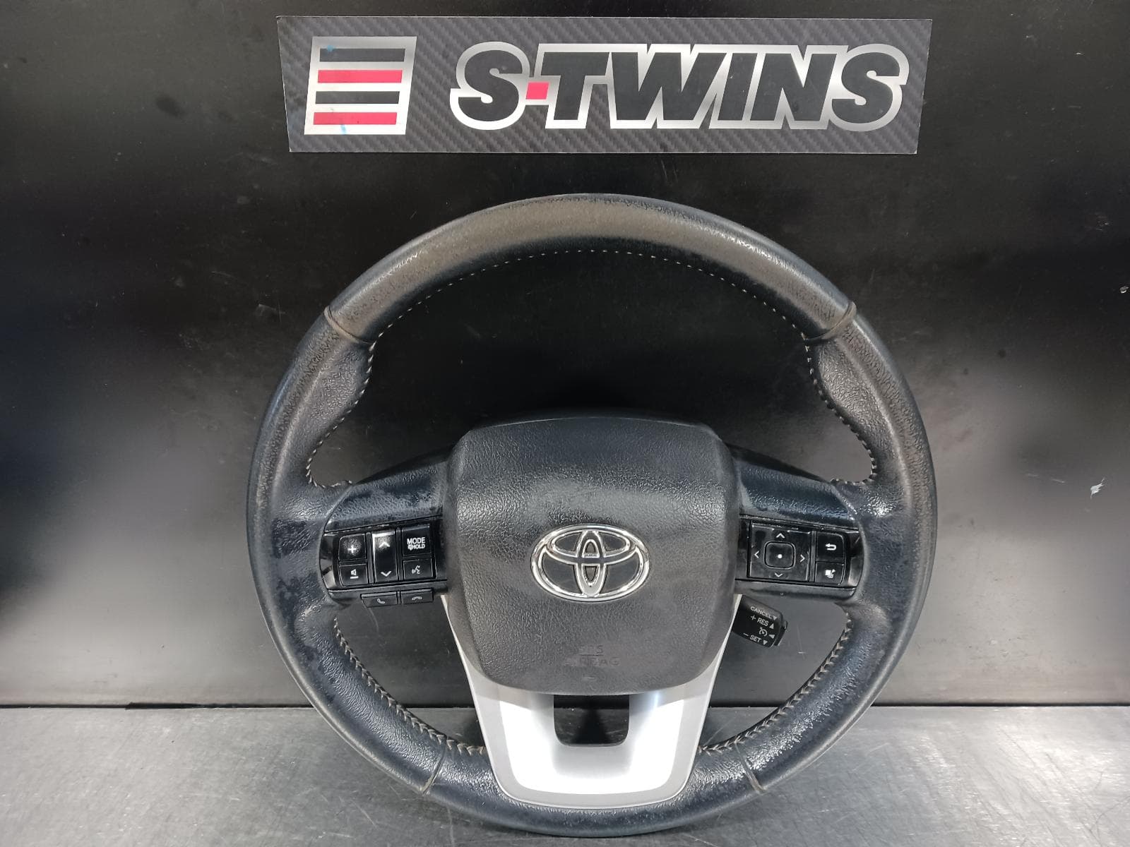 Used auto part listing image: 2017 TOYOTA HILUX STEERING WHEEL VINYL, W/ CRUISE/AUDIO/PHONE, DISPLAY CONTROLS, RADAR AND LANE CONTROLS TYPE, 06/15-09/25 0000206384