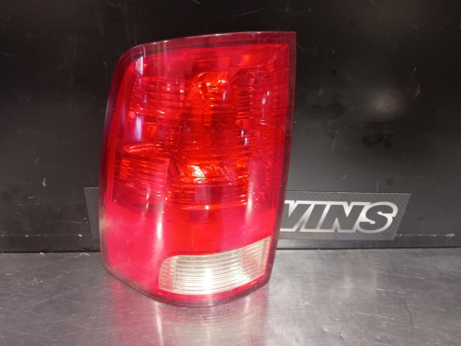 Used auto part listing image: 2021 RAM 1500 LEFT TAILLIGHT DS, NON LED TYPE, NON SMOKED LENS TYPE, 11/17- 0000218162