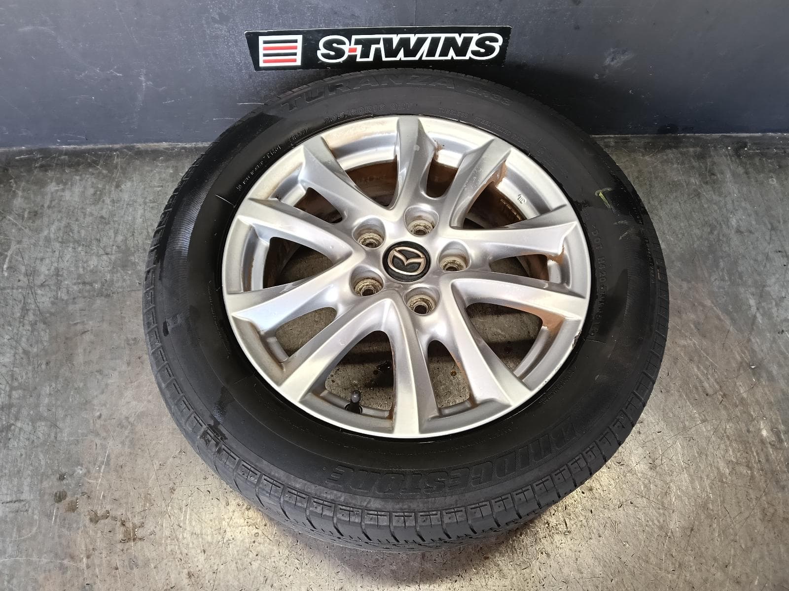 Used auto part listing image: 2014 MAZDA 3 WHEEL MAG FACTORY, 16X6.5IN, BM-BN, MAXX/TOURING, 11/13-02/19 0000415963