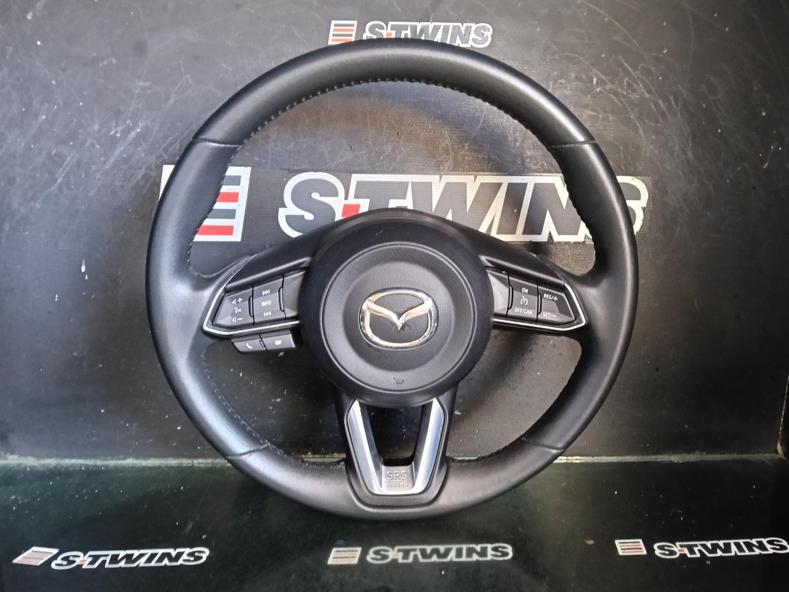 Used auto part listing image: 2019 MAZDA 2 STEERING WHEEL LEATHER, W/ CHROME SURROUND ON CONTROLS TYPE, DJ/DL, 01/17- 0000421807