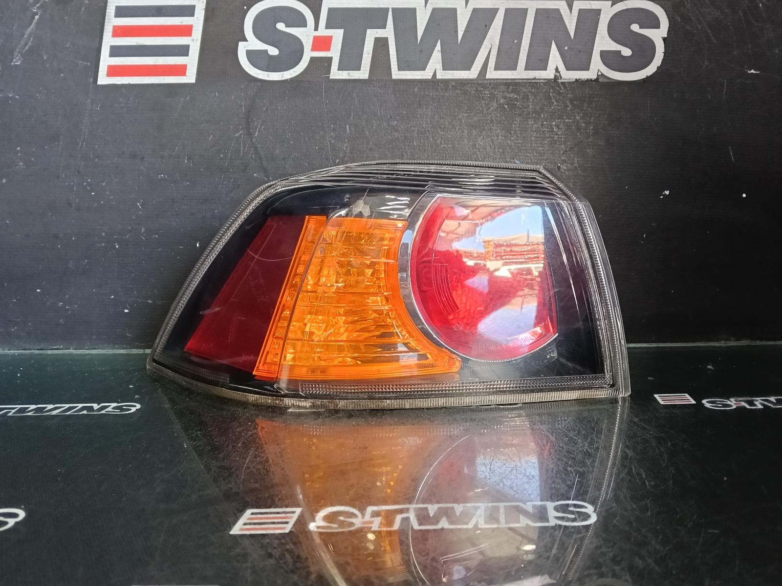 Used auto part listing image: 2014 MITSUBISHI LANCER LEFT TAILLIGHT CJ-CF, SEDAN, BLACK INSERT TYPE, 07/07-12/17 0000378885