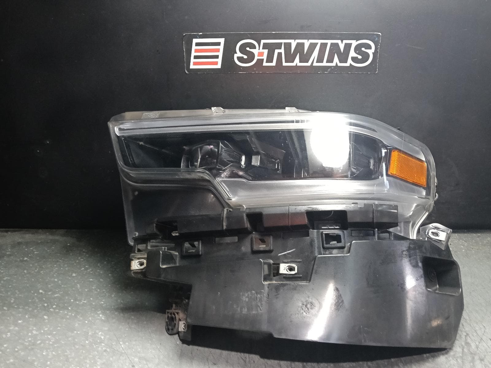 Used auto part listing image: 2021 RAM 1500 LEFT HEADLAMP DT, W/ LED, PROJECTOR, DAYTIME RUNNING LAMP TYPE, 10/20-12/23 0000411925