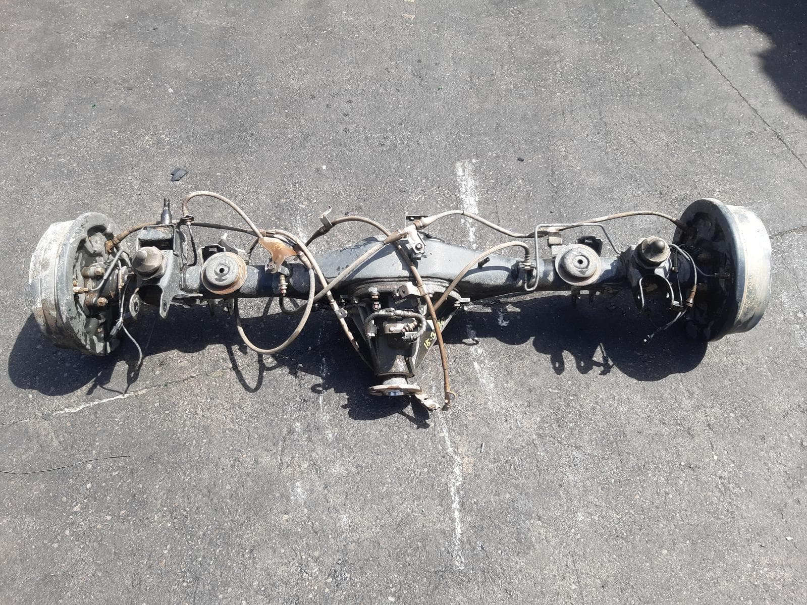 Used auto part listing image: 2021 NISSAN NAVARA REAR DIFF ASSEMBLY NP300, DIESEL, 2.3, TWIN TURBO, 4WD, MANUAL T/M, 3.692 RATIO, W/ DIFF LOCK, COIL SPRING TYPE, 01/21- 0000372556