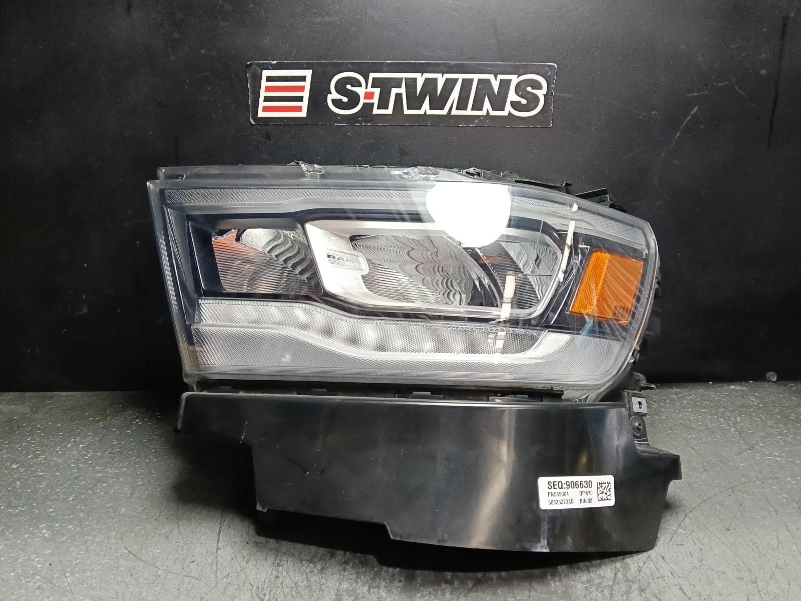 Used auto part listing image: 2023 RAM 1500 LEFT HEADLAMP DT, W/ LED, PROJECTOR, DAYTIME RUNNING LAMP TYPE, 10/20-12/23 0000414749